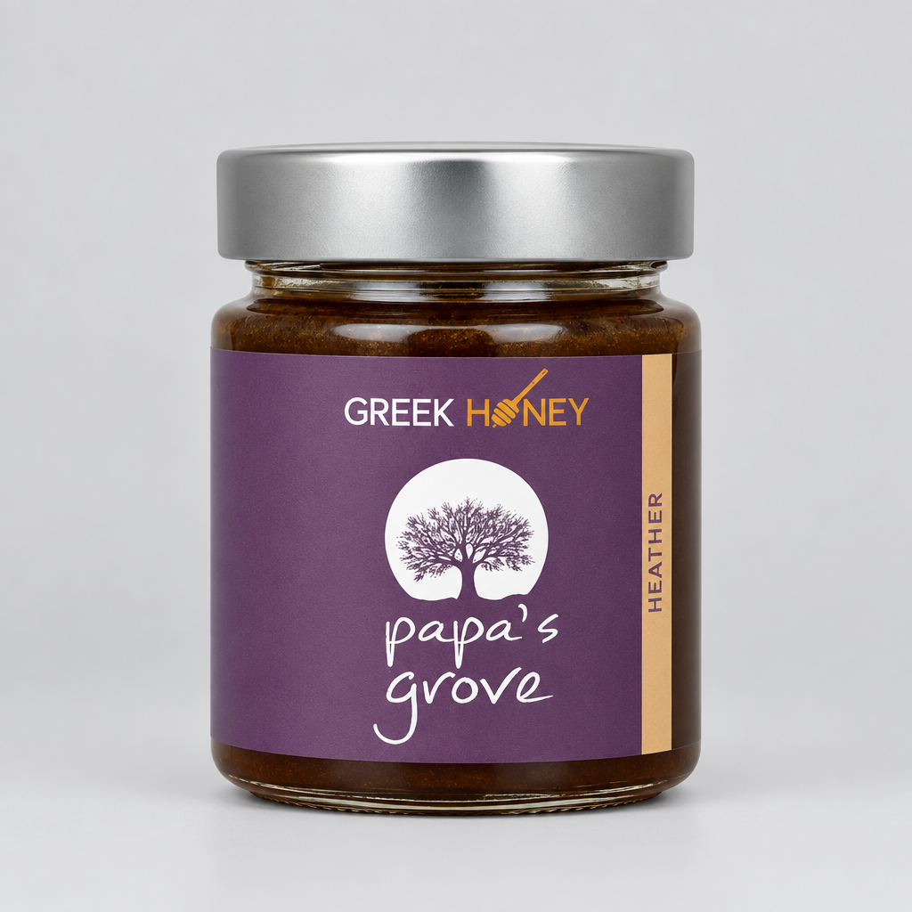 A close up of a glass jar of Greek Raw Heather Honey from Papa's Grove, featuring a purple label with a tree logo and a sliver metal lid, set against a neutral gray background.