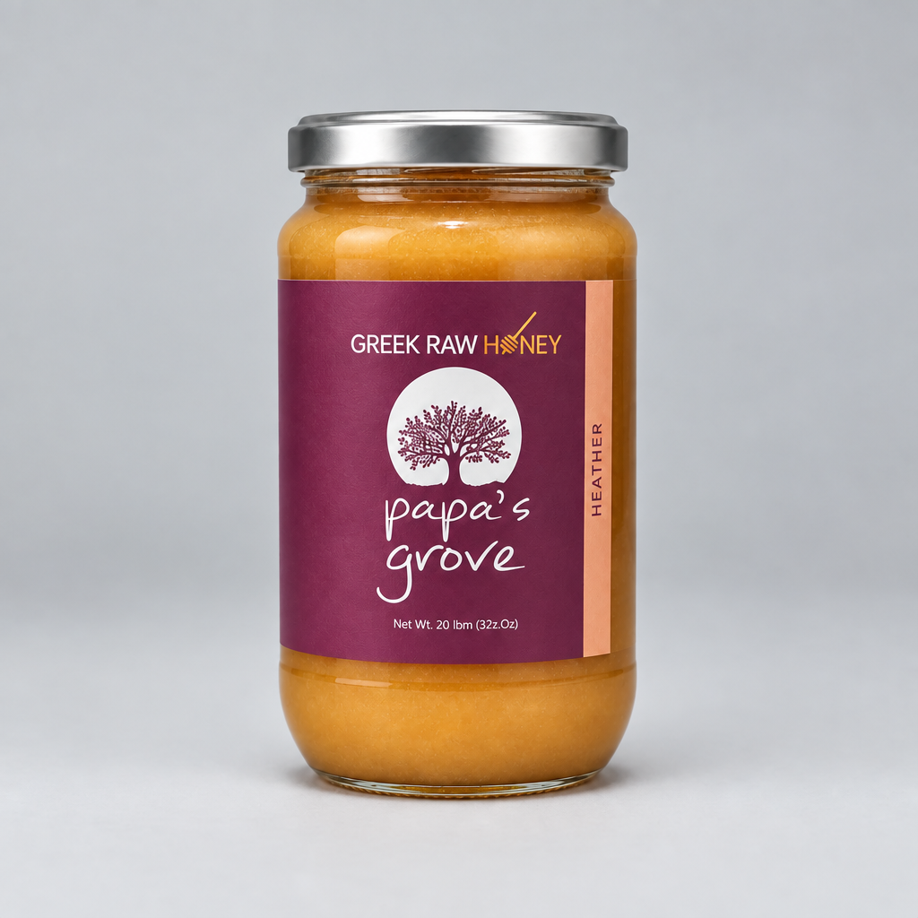 A tall glass jar of Greek Raw Heather Honey from Papa's Grove, featuring a deep purple label with a tree logo and a sliver metal lid, set against a neutral gray background.