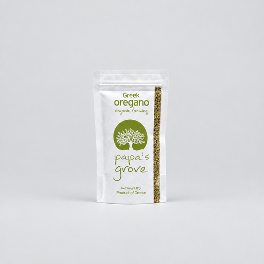 A stand-up pouch of Greek oregano organic farming by Papa's Grove, featuring a white bag with green text and logo, and a clear window showing the dried oregano leaves inside, set against a light gray background.